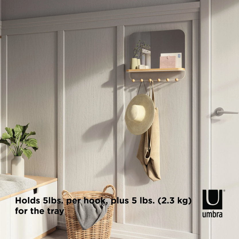 Umbra Estique mirror with hooks and tray mounted beside a front door