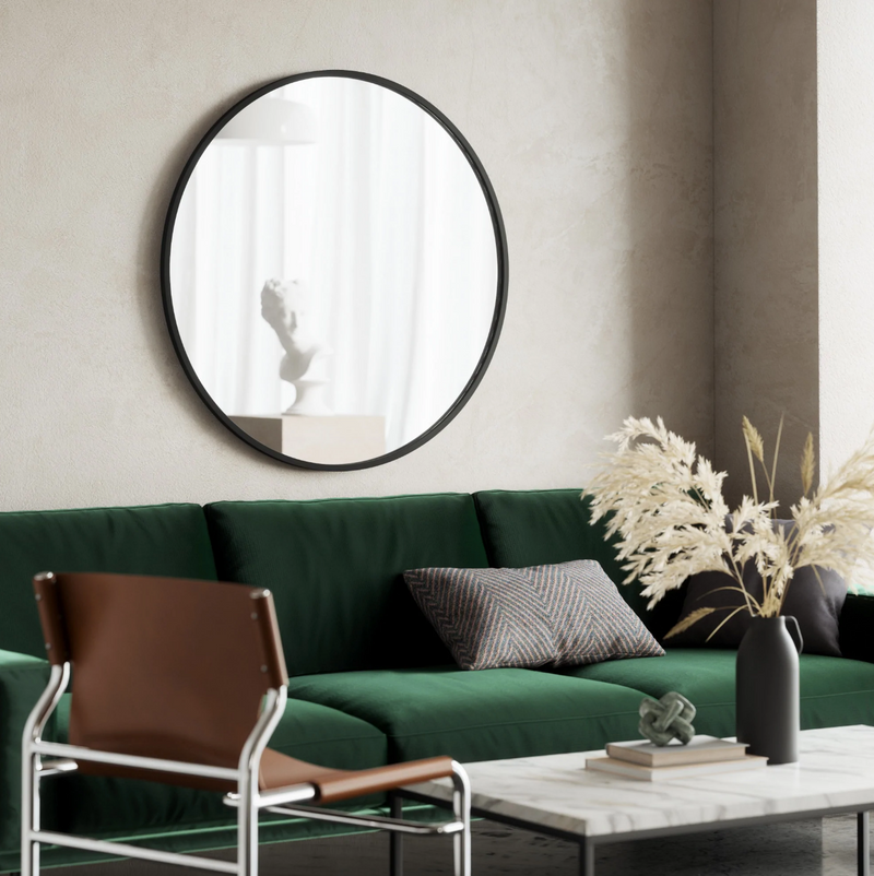 A modern living room with a green couch and an Umbra HUB MIRROR - Large.