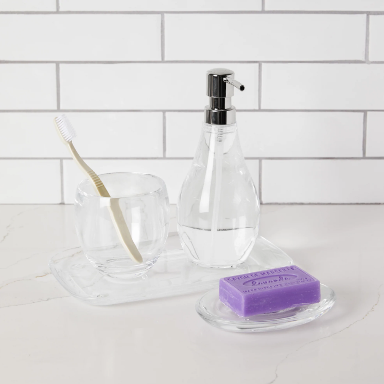 The DROPLET Bathroom Tumbler, part of the Bath Accessory Collection by Umbra Design, features a glass tray with both a soap dispenser and a TOOTHBRUSH HOLDER.