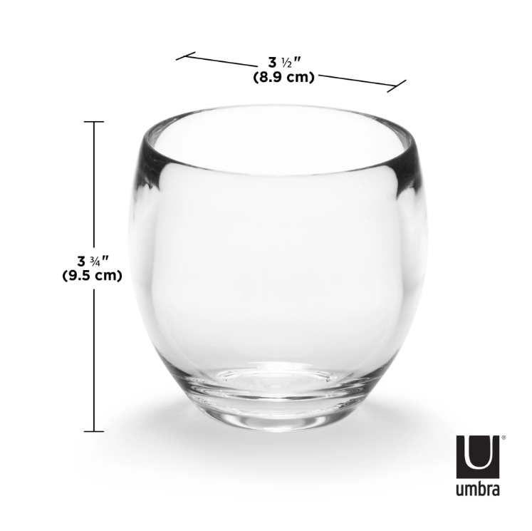 The Umbra Design DROPLET TUMBLER / TOOTHBRUSH HOLDER - CLEAR is a sleek bath accessory from the Bath Accessory Collection. Made of clear glass, this tumbler features measurements for precise usage.