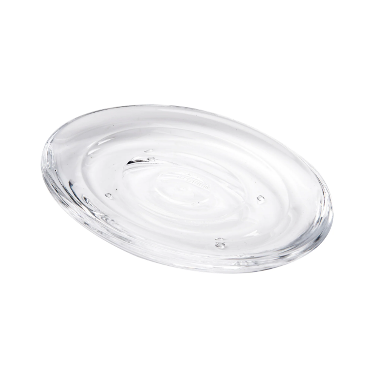 A clear glass plate on a white background, perfect for bathroom décor items or displaying the Droplet Soap Dish by Umbra, DROPLET SOAP DISH, CLEAR.