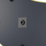 A black and yellow HUBBA PEBBLE MIRROR wall plate by Umbra with a metallic finish and a mirror-like button on it.