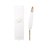 An AXEL & ASH White Feather Pen gracefully placed next to a sleek white box, exuding elegance and sophistication.