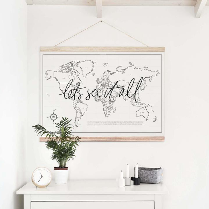 A Let's See It All dresser adorned with a captivating world map, appealing to the wanderlusting soul by AXEL & ASH.