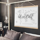 A wanderlusting soul's bedroom adorned with a Let's See It All map from AXEL & ASH, elegantly hung above the bed.
