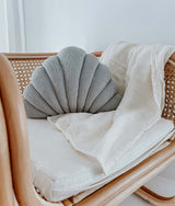 A rattan chair with a Small Shell Cushion - Mist / Nougat made of pure cotton by Bengali Collections.