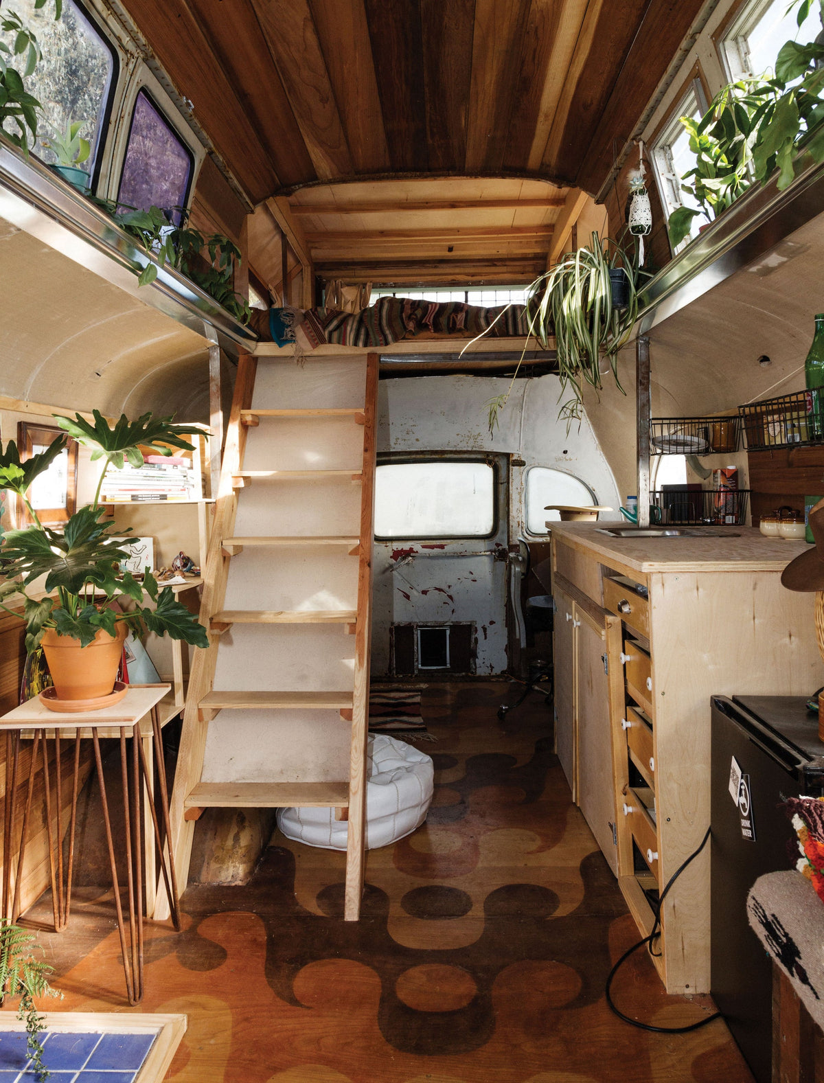 A "Surf Shacks: An Eclectic Compilation Of Creative Surfers Homes From Coast To Coast and Overseas" ladder in a Books surf shack.