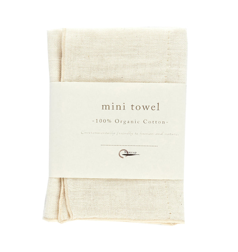 A NAWRAP ORGANIC MINI TOWEL - IVORY, by Flux Home, perfect for sensitive skin, featuring the word 'mini' and crafted with natural materials.