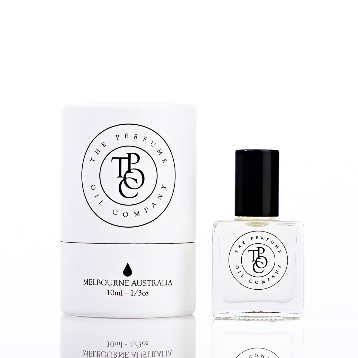 A bottle of NUDE perfume with a box next to it, inspired by Beige (CC), from The Perfume Oil Company.