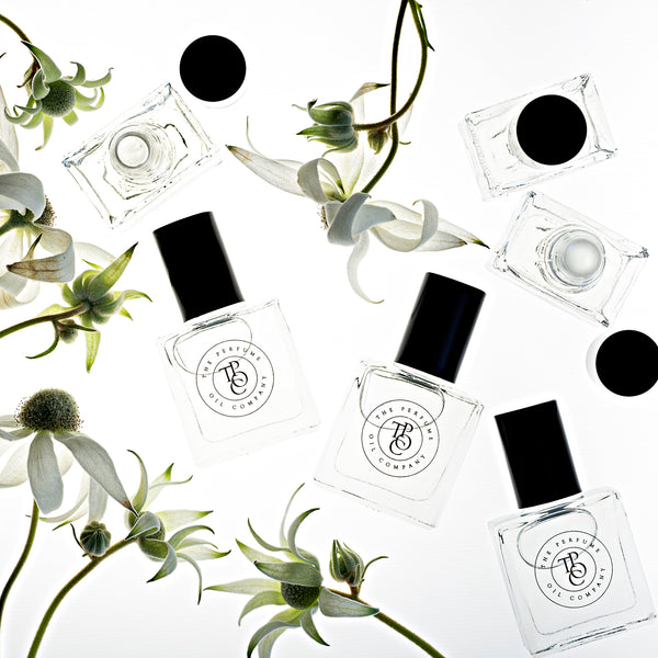 A collection of PASSION bottles, inspired by Mon Paris (YSL), from The Perfume Oil Company, with flowers on them.
