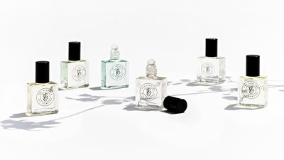 Five bottles of KOKO Roll-On Perfume Oils by The Perfume Oil Company on a white surface.