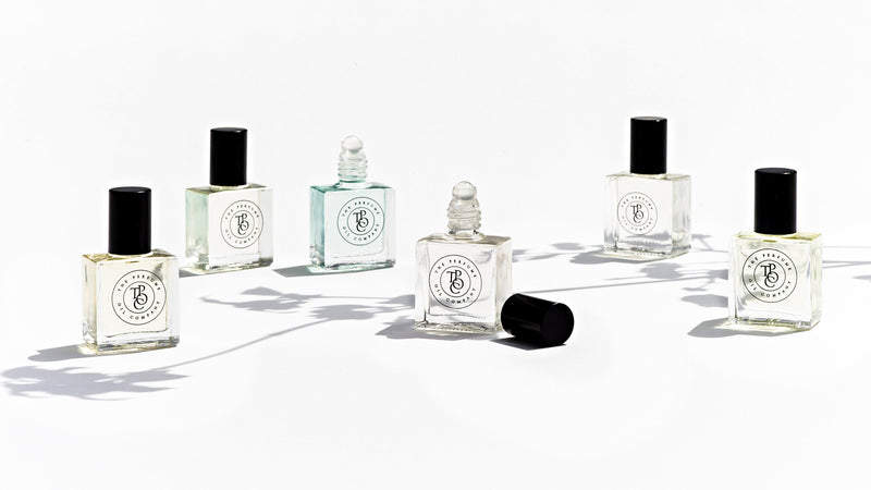 Five bottles of KASBAH perfume oil sitting on a white surface (by The Perfume Oil Company).