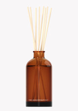 The Aromatherapy Co Reed diffuser with Therapy® Diffuser Balance - Cinnamon & Vanilla Bean aroma in a brown glass bottle.