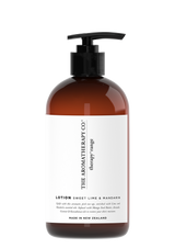 A bottle of Therapy® Hand & Body Lotion - Sweet Lime & Mandarin by The Aromatherapy Co with a white bottle on a black background, infused with the uplifting aromas of Lime and Mandarin essential oils.