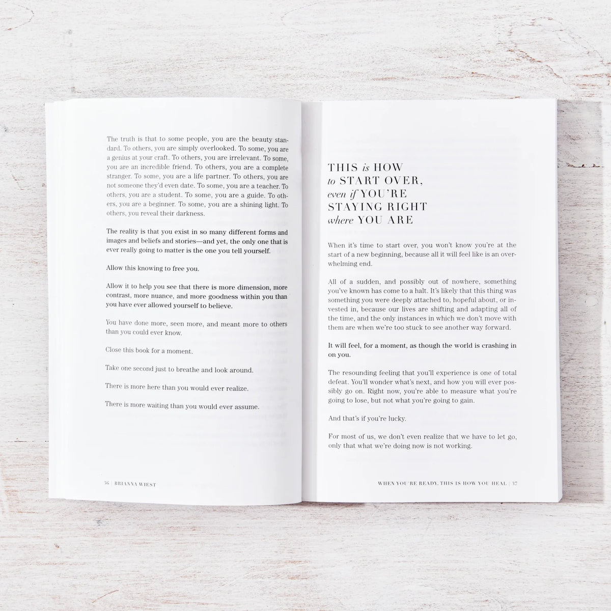 A motivational self-help book by Brianna Wiest open on a wooden table.