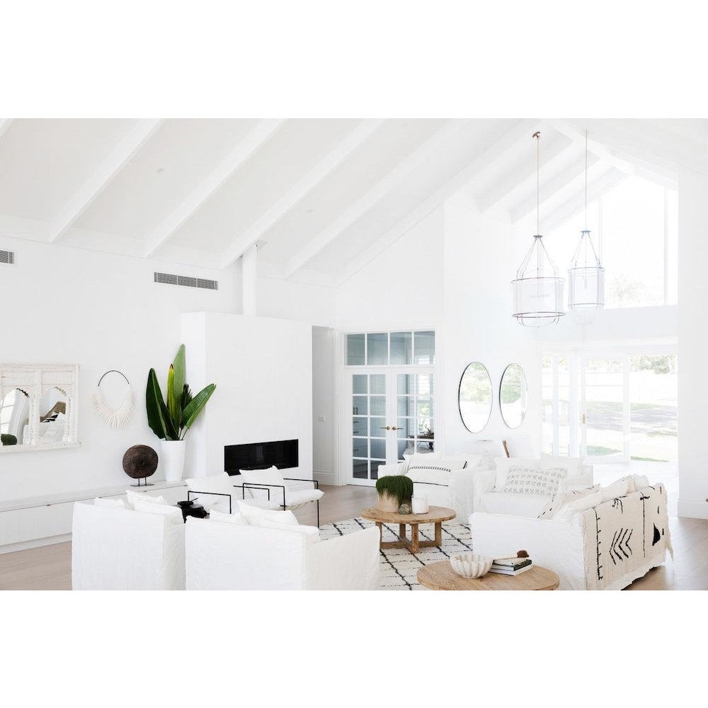 Stack of Three Birds Renovations books styled in a white living room