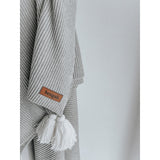 A Ribbed Tassel Throw | Grey from Bengali Collections, an Oeko-tex® certified cotton blanket with a tassel on it.