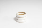 A stack of white ceramic HAZY POT mugs with a matte finish on a white surface, from Ned Collections.