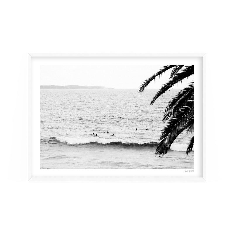 A black and white photo of surfers in the ocean available for Surf's Up prints and delivery by Art Prints.