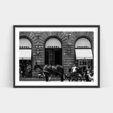 A black and white photo of a horse drawn carriage in front of a Chanel store, available as a Fashionably Late print by Art Prints.