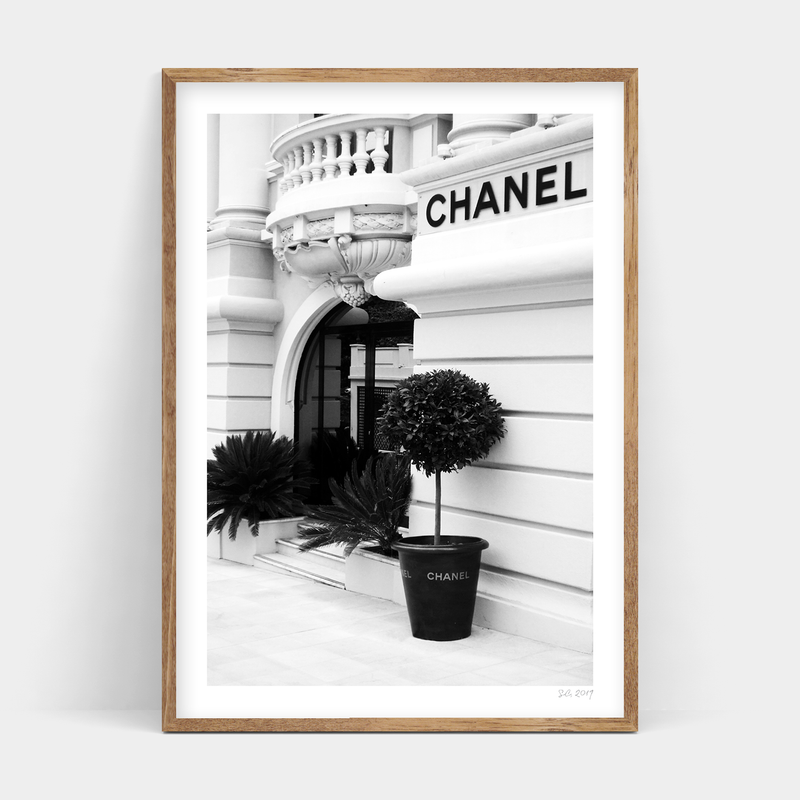 A black and white photo of a Chanel building available for delivery as Make an Entrance framed prints from Art Prints.