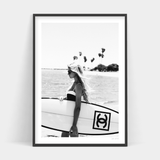 A black and white photo of a woman holding the Surfer Chic surfboard available for Art Prints prints and delivery.