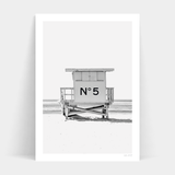 A black and white print of a lifeguard tower on the beach from Number 5 by Art Prints, available for frames.