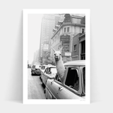 A black and white photo of a New York Taxi in a car, available for prints and framed delivery by Art Prints.