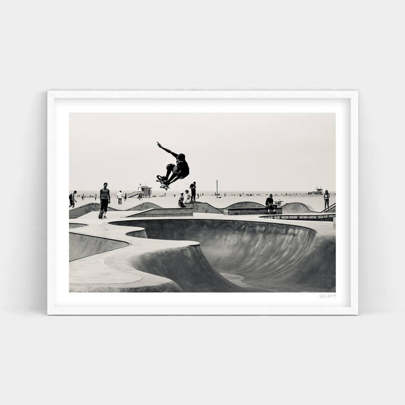 A black and white photo of a skateboarder performing tricks in Oceanfront Park, available for delivery as Art Prints or frames.
