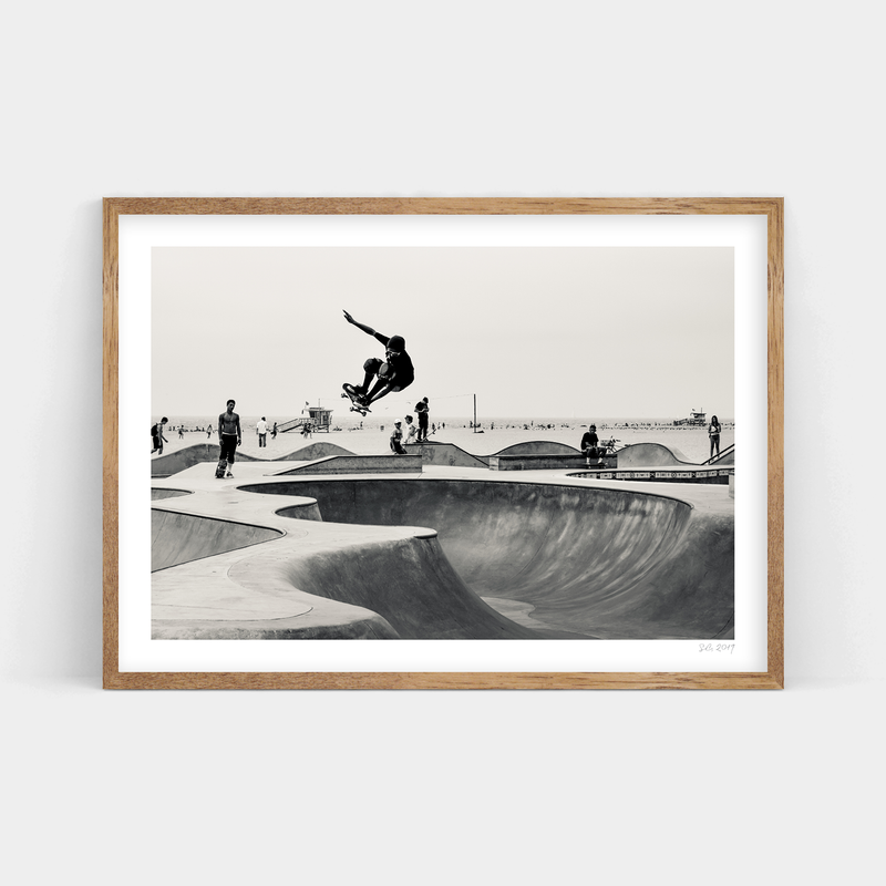 A black and white photo of a skateboarder in Oceanfront Park, available for delivery by Art Prints.