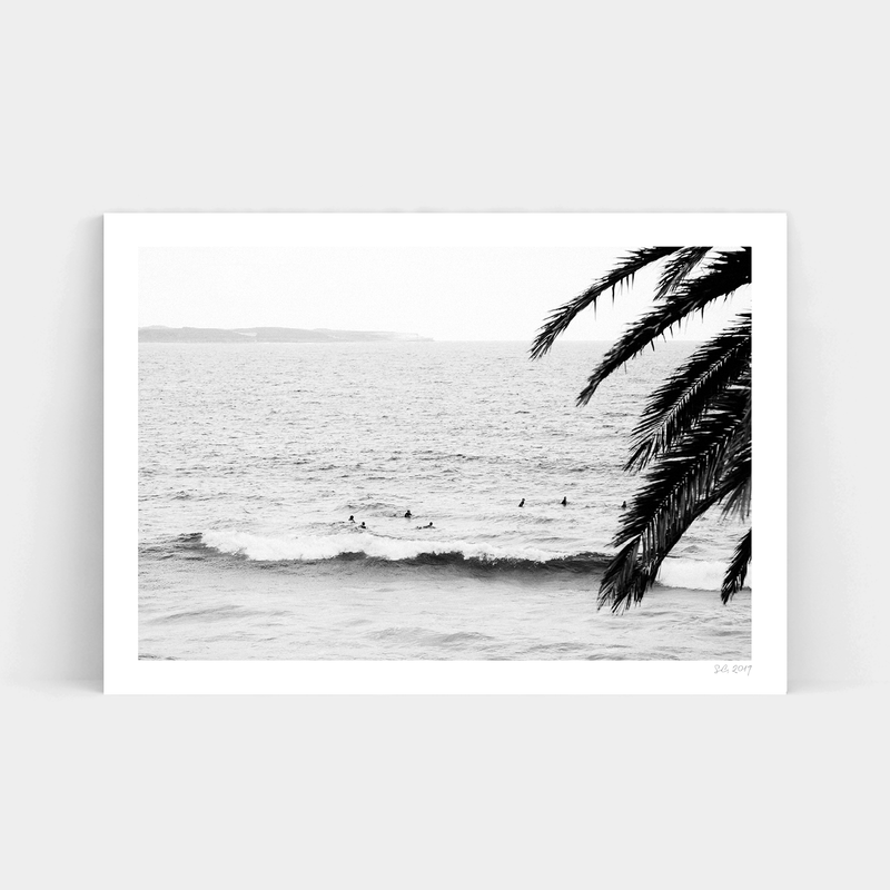 A black and white photo of surfers in the ocean, available for delivery as Surf's Up prints from Art Prints.