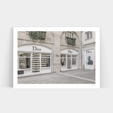 A black and white photo of an Art Prints dior store displaying elegant frames.