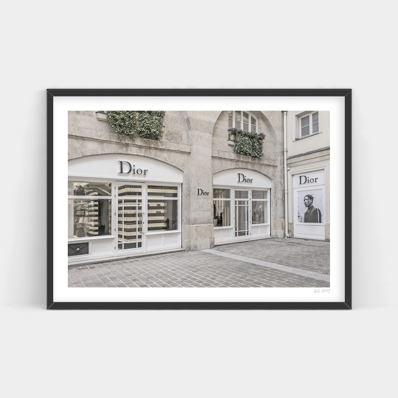 A black and white photo print of a Dior Art Prints storefront in Paris.