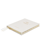 A white Little Dreamer Baby Journal notebook with gold lettering on it, an ideal gift for a baby shower.