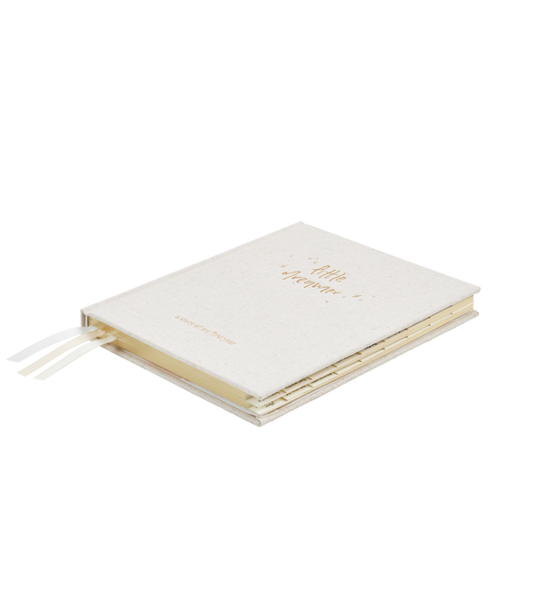 A white Little Dreamer Baby Journal notebook with gold lettering on it, an ideal gift for a baby shower.