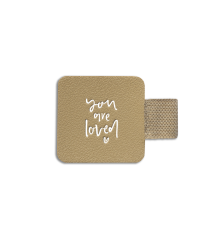 An accessory, a self-adhesive Pen Holder | Latte with the words 'you are loved' on it by Emma Kate Co.