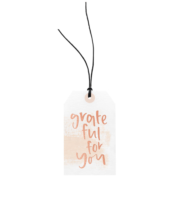 An Emma Kate Co Grateful For You gift tag, tied with hemp twine.