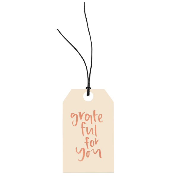 An environmentally responsible Emma Kate Co gift tag attached with hemp twine that says Grateful For You.