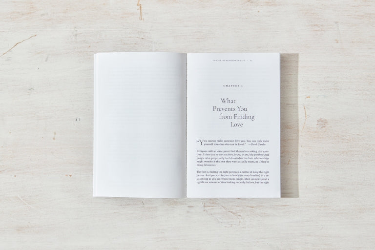 Book open on whitewashed timber, angled view