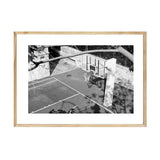 A black and white photo of a basketball court available for PAPIER HQ | BASKETBALL HOOP PRINTS by Art Prints.