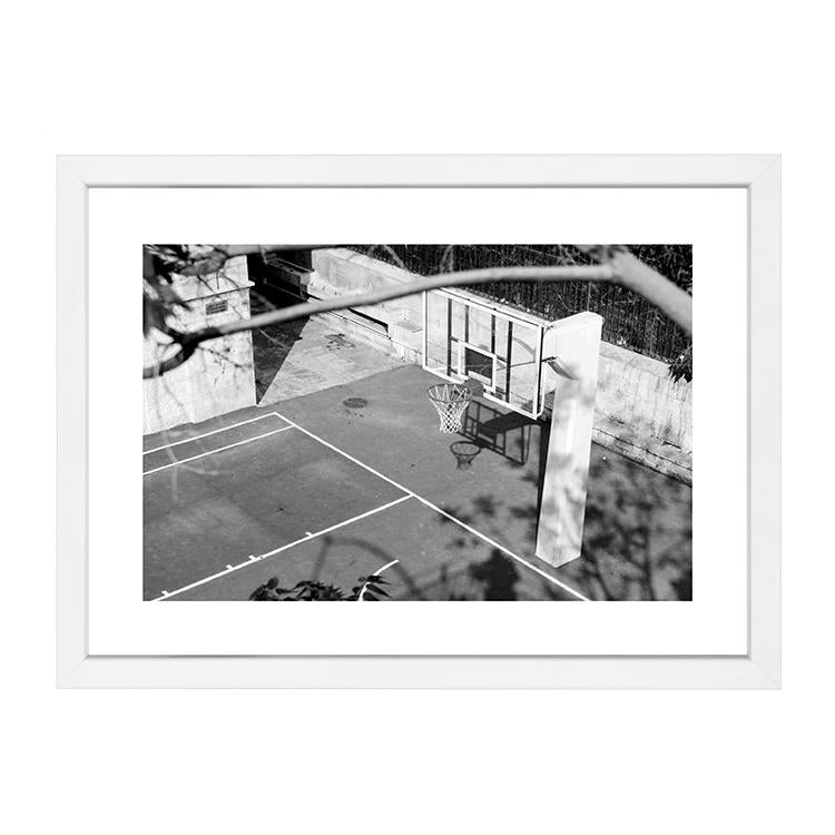 A black and white photo of a PAPIER HQ | BASKETBALL HOOP PRINT by Art Prints available for delivery.