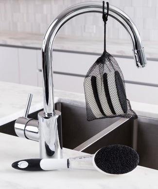 A kitchen sink with a Barkly Basics Scourer Pad Dish Stick featuring a heavy duty scourer head and a replaceable head.