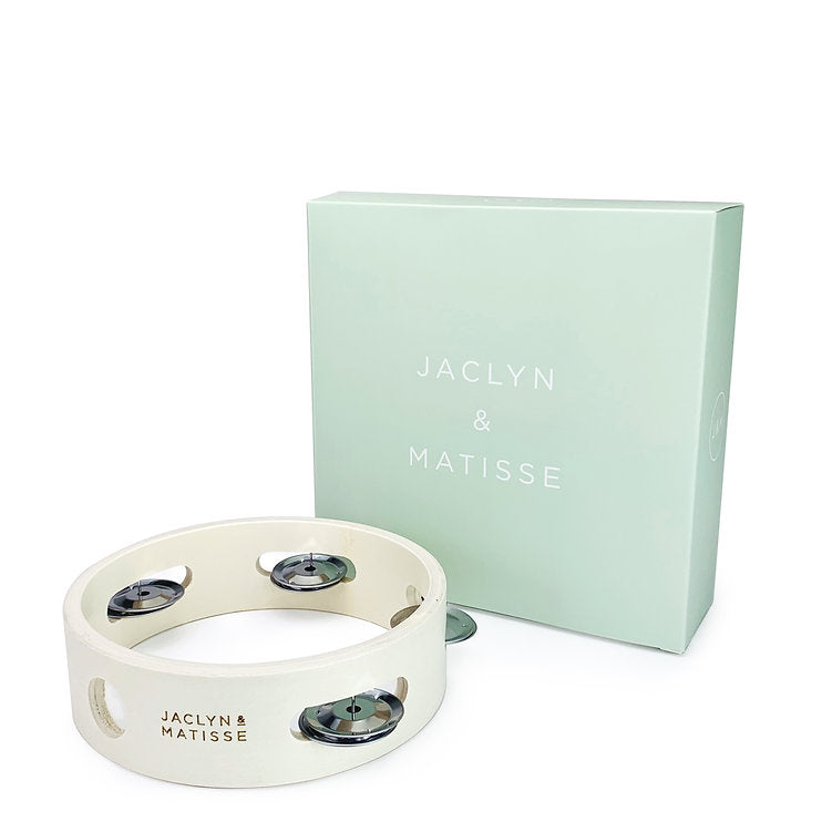 White tambourine beside its mint green gift box, on white