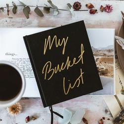 A black journal with the words 'My BUCKETLIST' on it by AXEL & ASH.