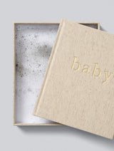 Linen baby memory book with gold lettering presented in keepsake box