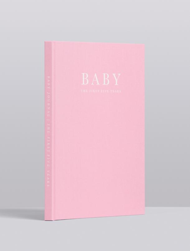 Pink linen Write To Me Baby journal standing upright, angled view of the embossed cover