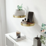 A decorative gold Umbra Perch Shelf Set-of-2 - Brass with a plant and phone gracefully placed on it.