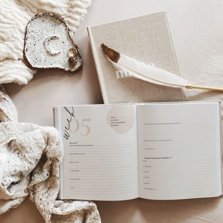 A Becoming MAMA - A Pregnancy Journal by AXEL & ASH captures the journey of motherhood with a feather and a pen, perfect for the nursery or as a thoughtful baby shower gift.