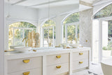 A stunning white and gold bathroom with large windows, offering a perfect blend of Three Birds Renovations: Dream Home How-To goodness and home transformations.