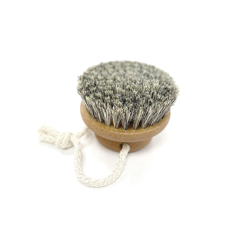 A Florence DRY MASSAGE BRUSH with a rope for massage.
